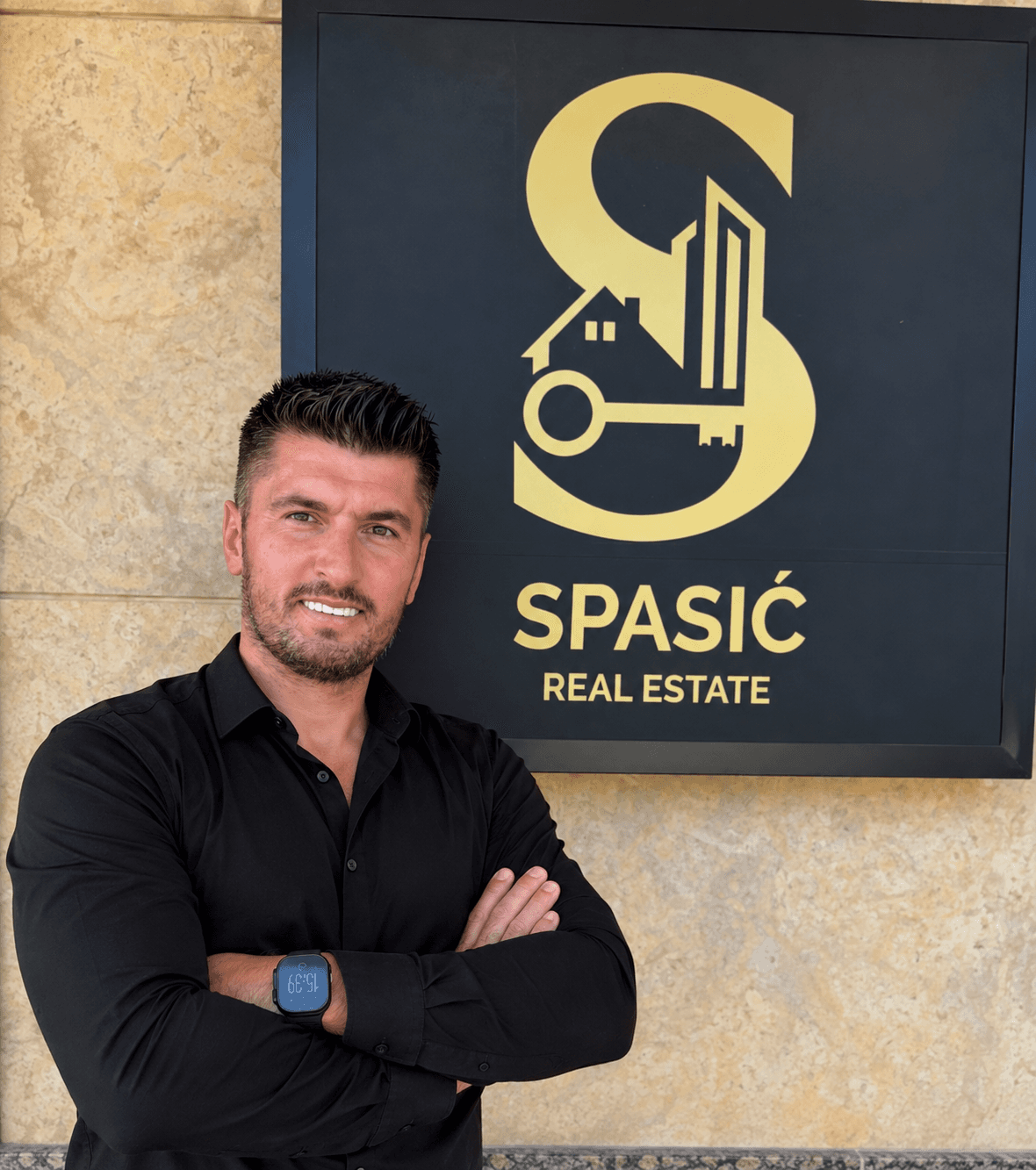 Stefan Spasić in front of the Spasić Real Estate sign